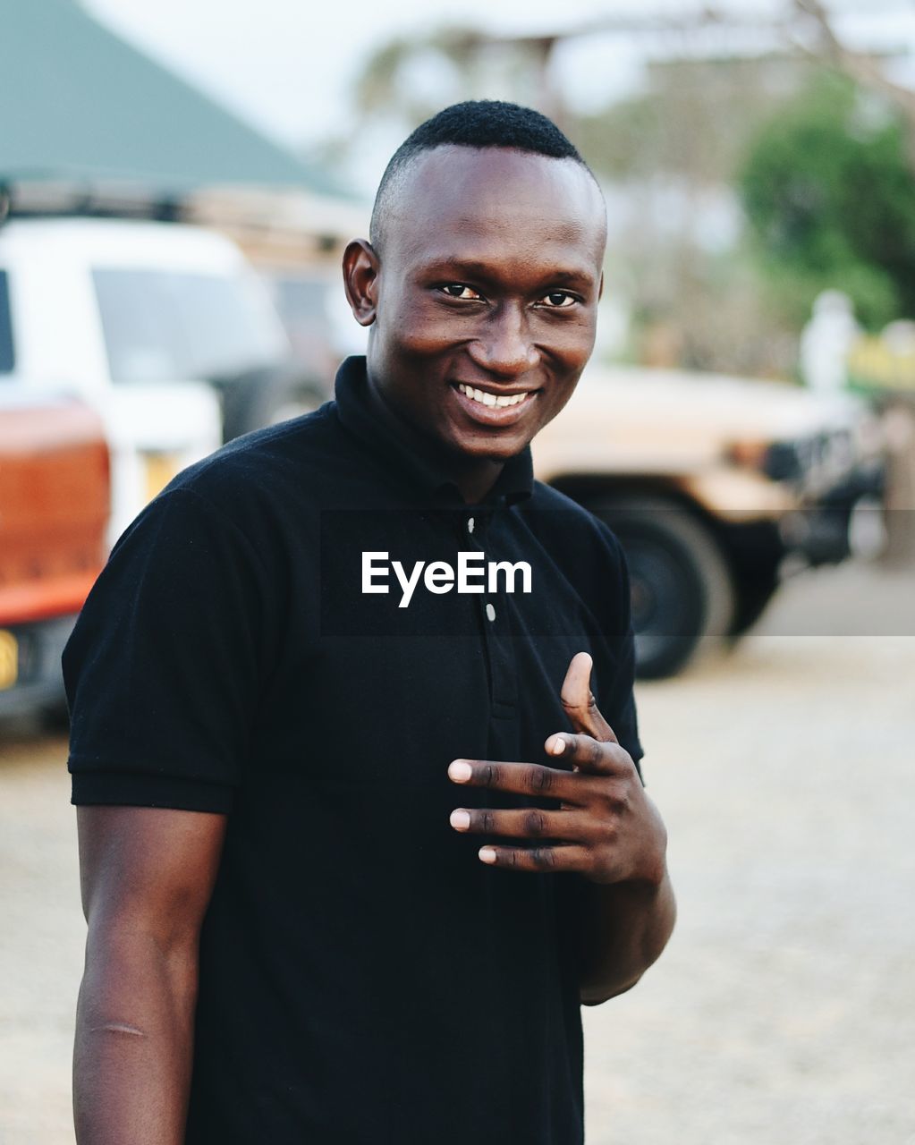 Portrait of happy man standing on street