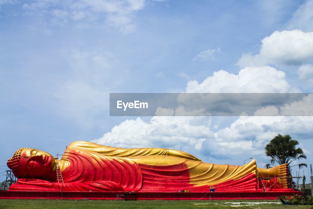 Low angle view of yellow temple against sky