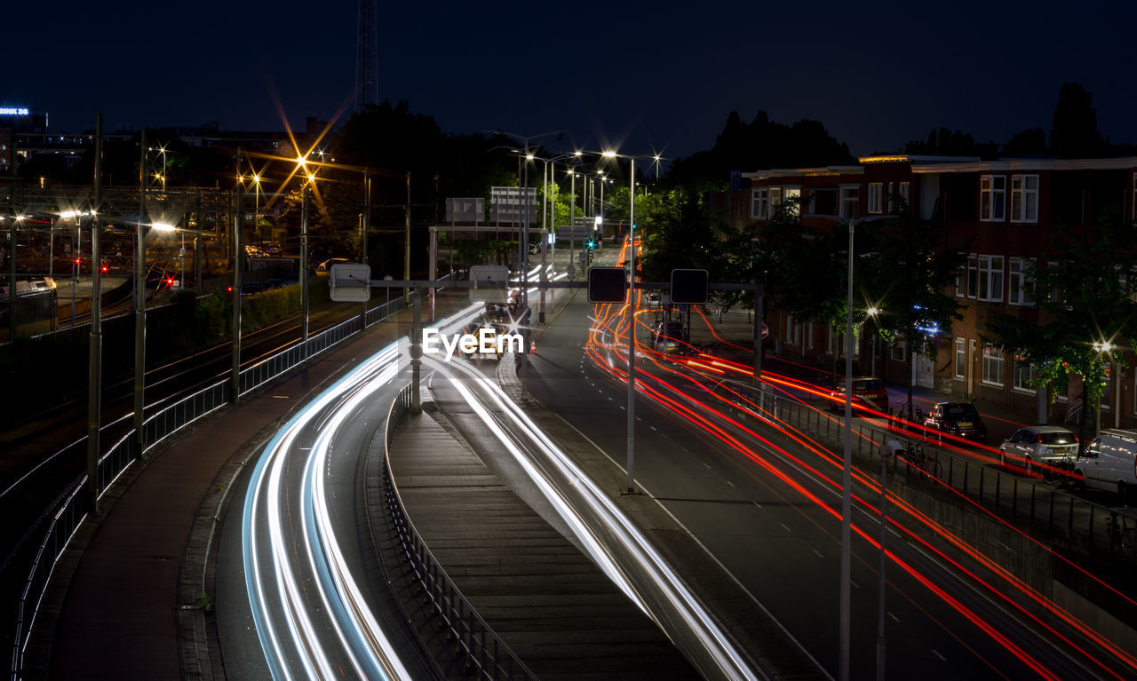 High angle view of light trails on road at night