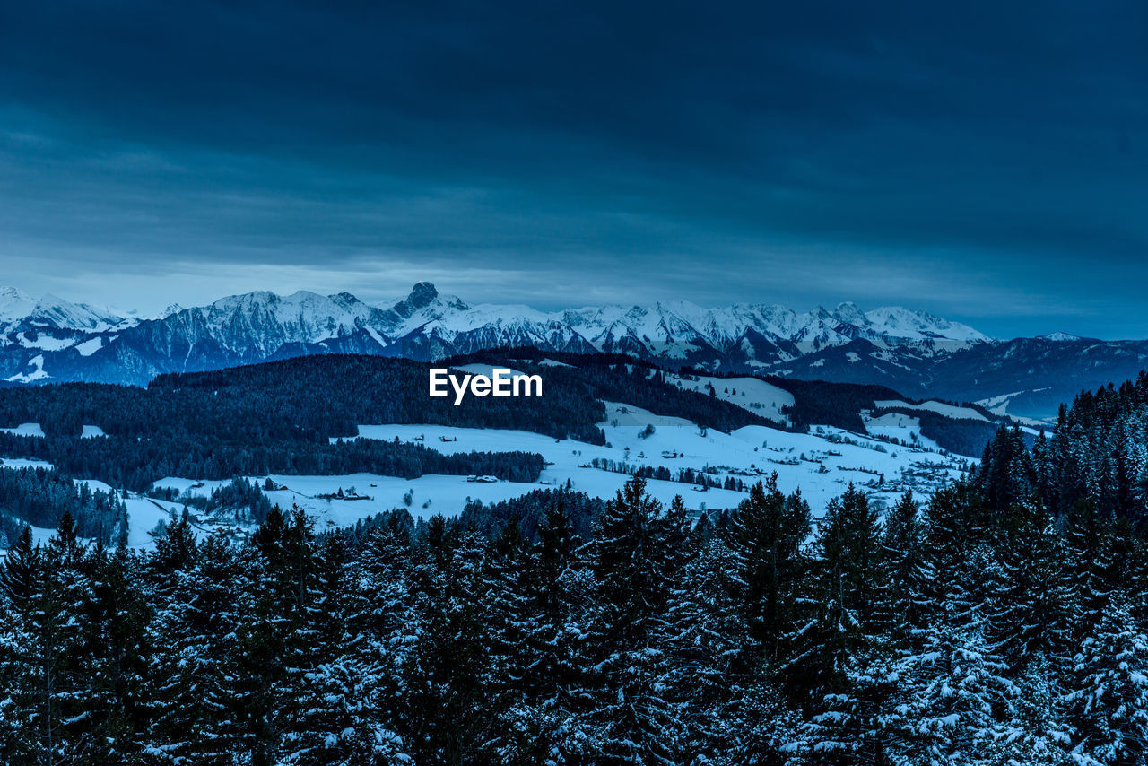 Scenic view of mountains against sky during winter