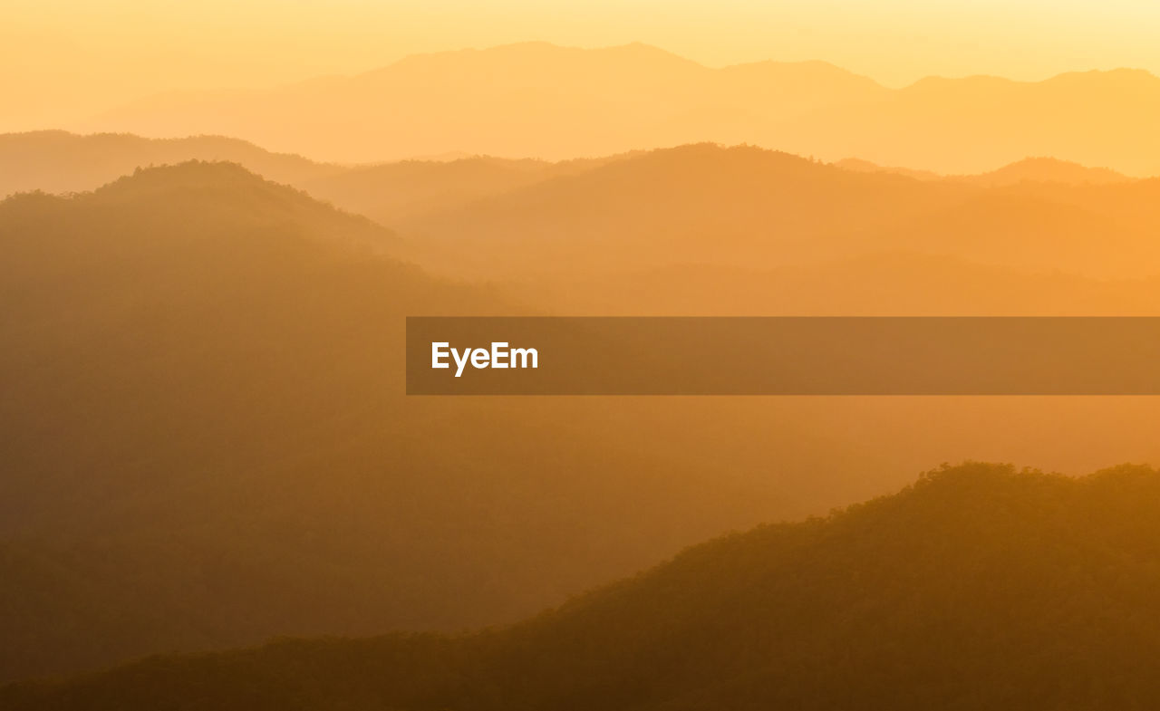 SCENIC VIEW OF MOUNTAINS AGAINST SKY DURING SUNSET