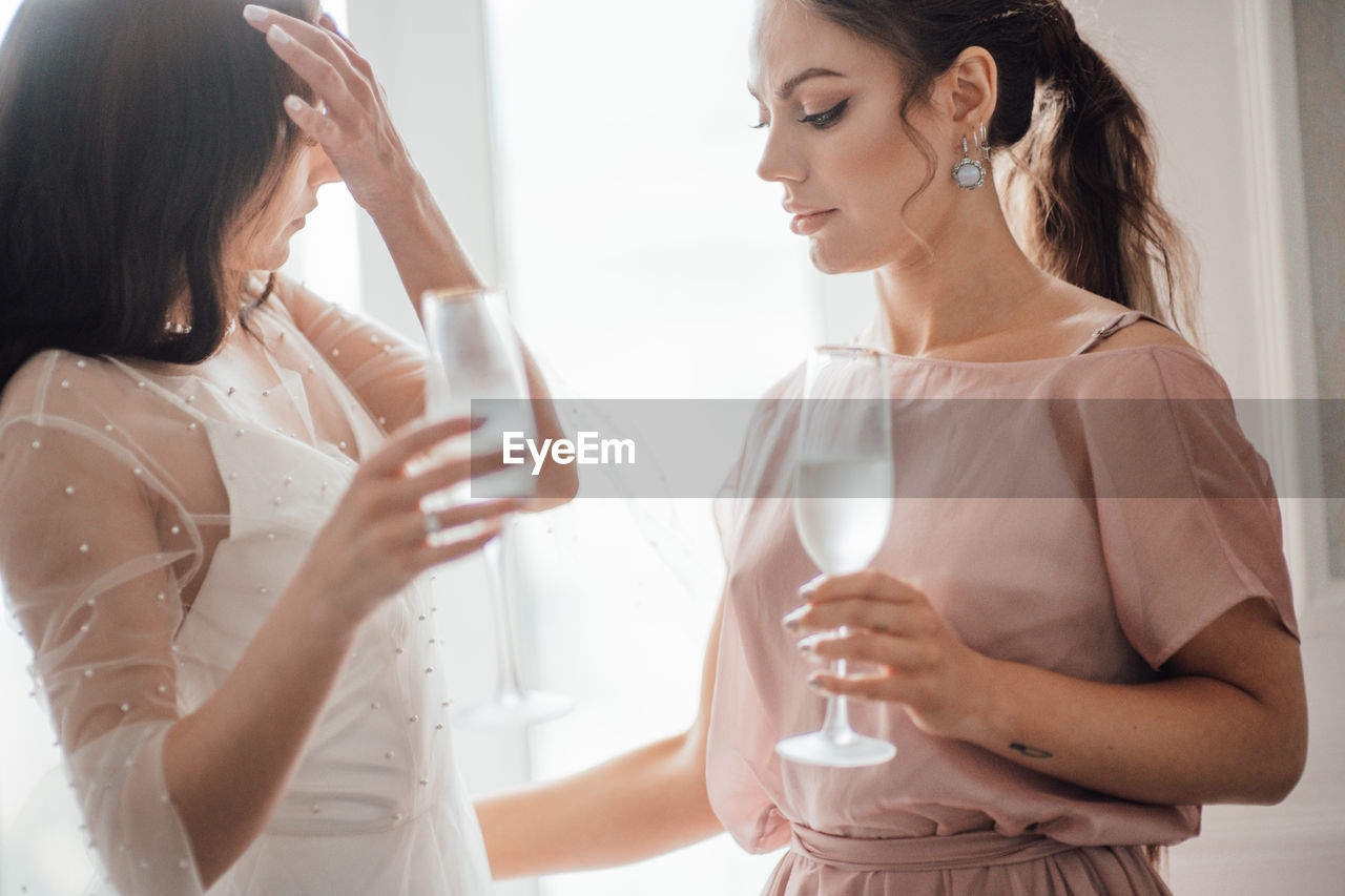 Midsection of woman drinking glass