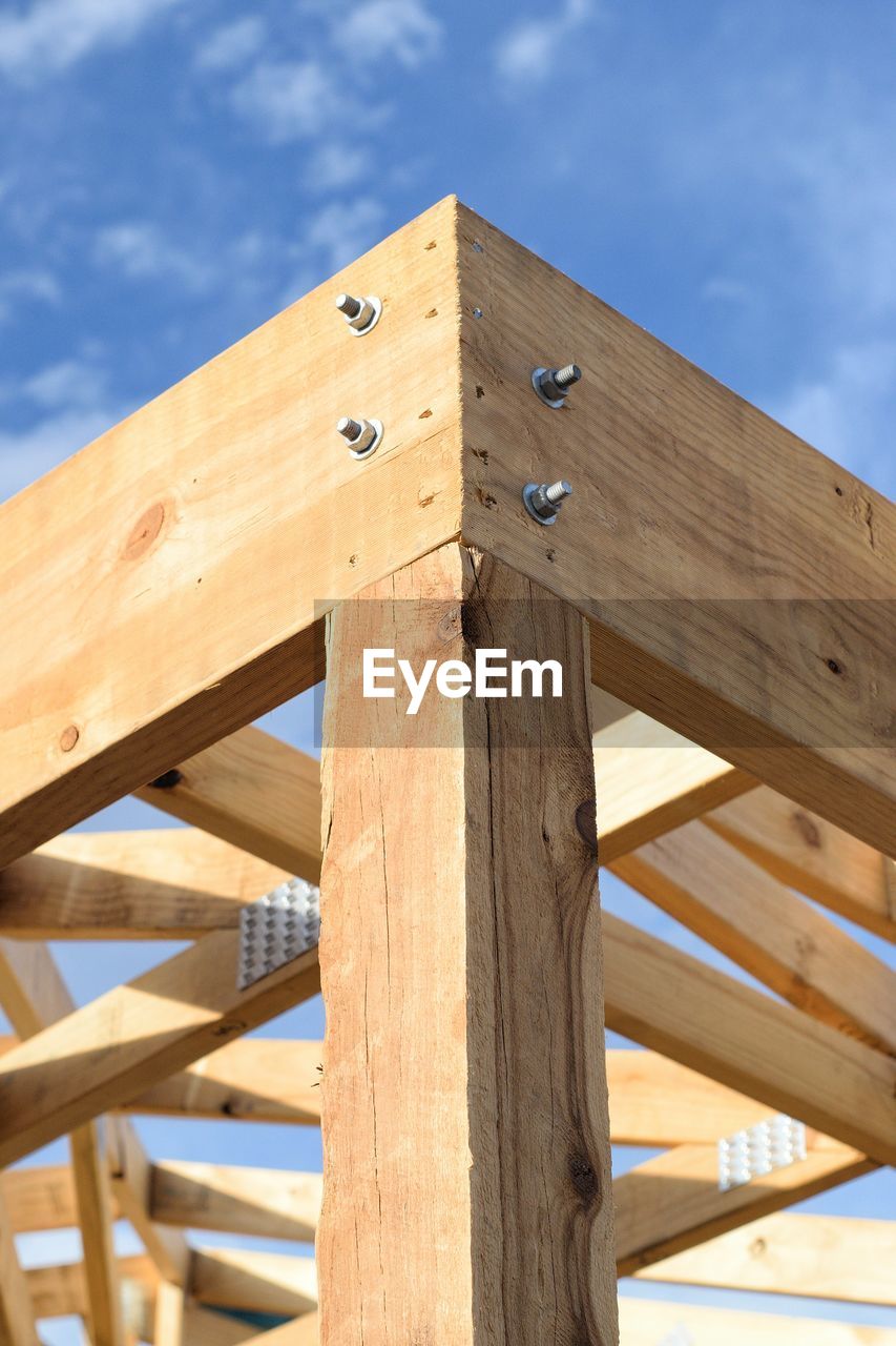 Low angle view of wooden structure against sky