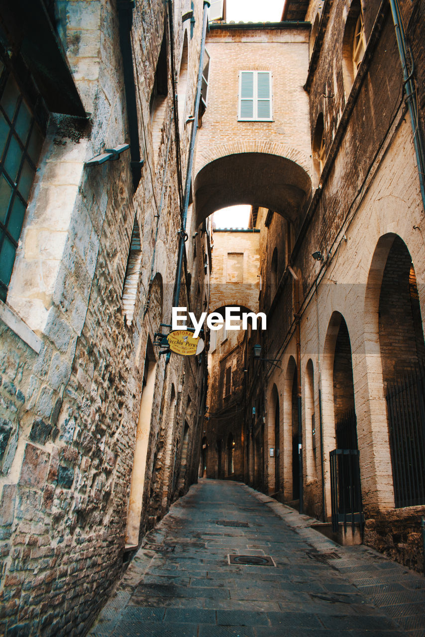 NARROW ALLEY AMIDST OLD BUILDINGS