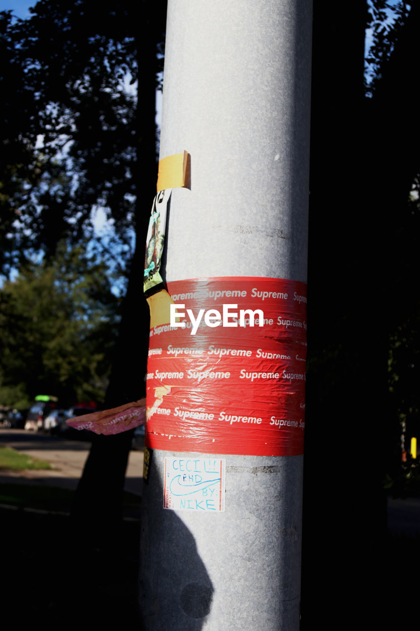 CLOSE-UP OF ROAD SIGNS AGAINST TREES