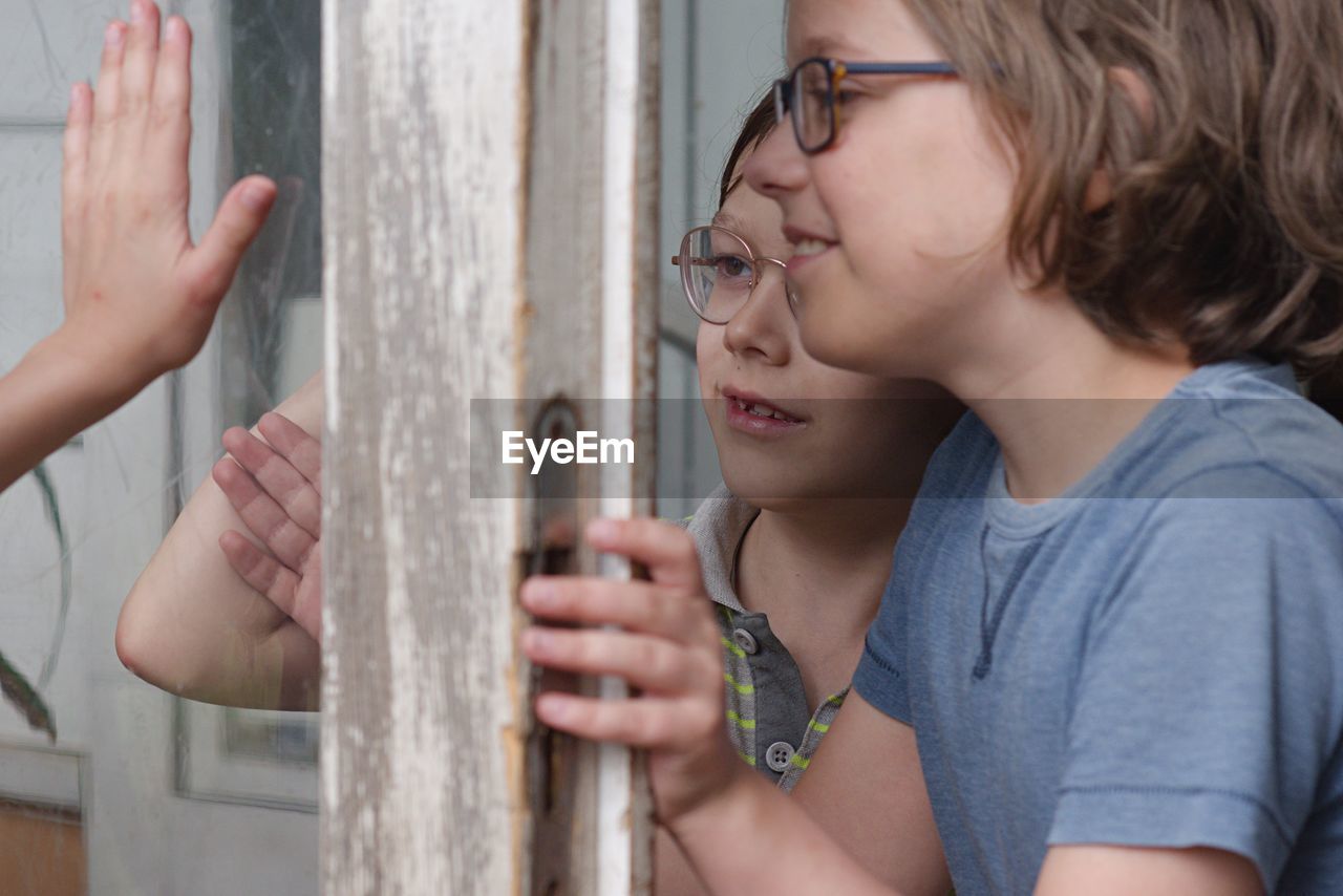 Boys standing by window