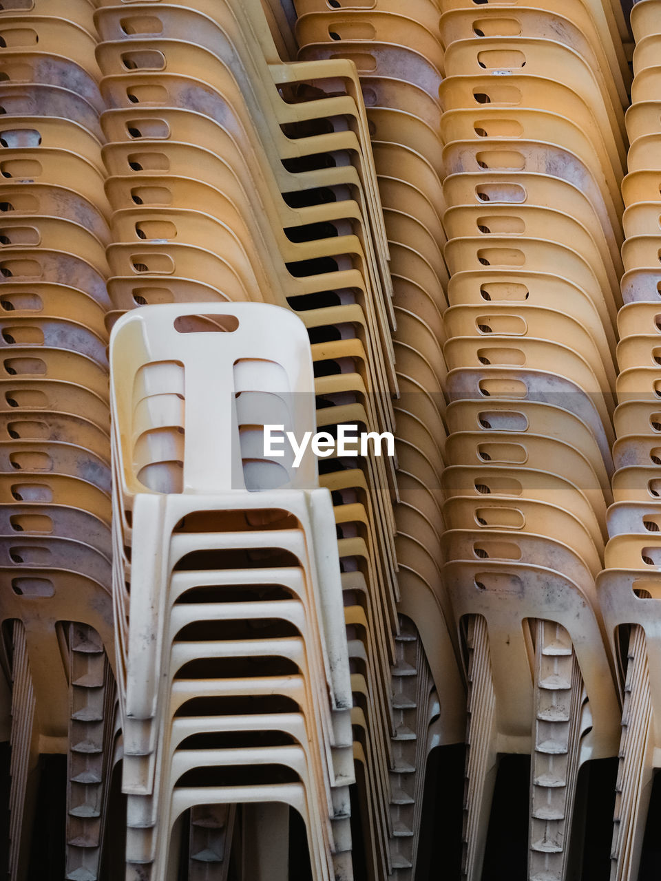 Full frame shot of stacked plastic chairs