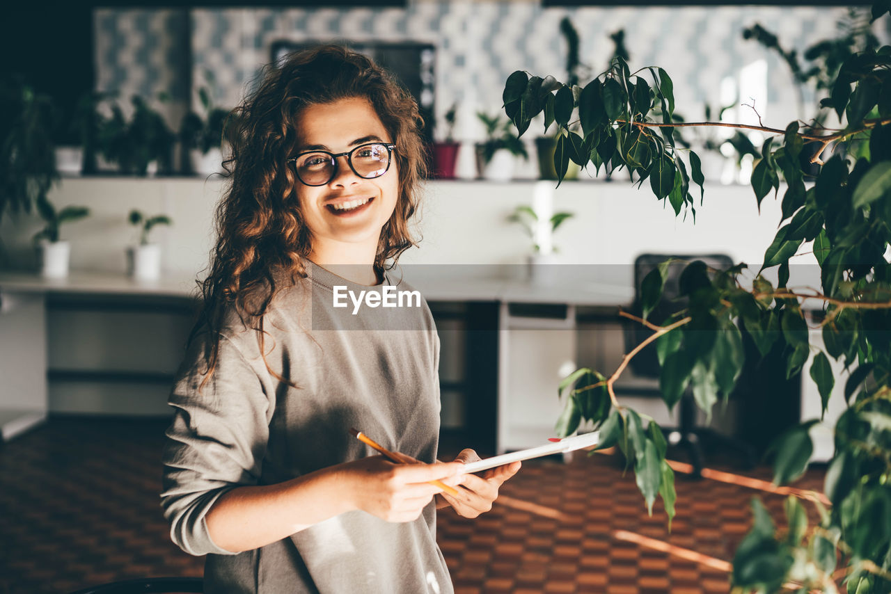 Freelancer woman using laptop at comfortable office, green co-working modern workplace