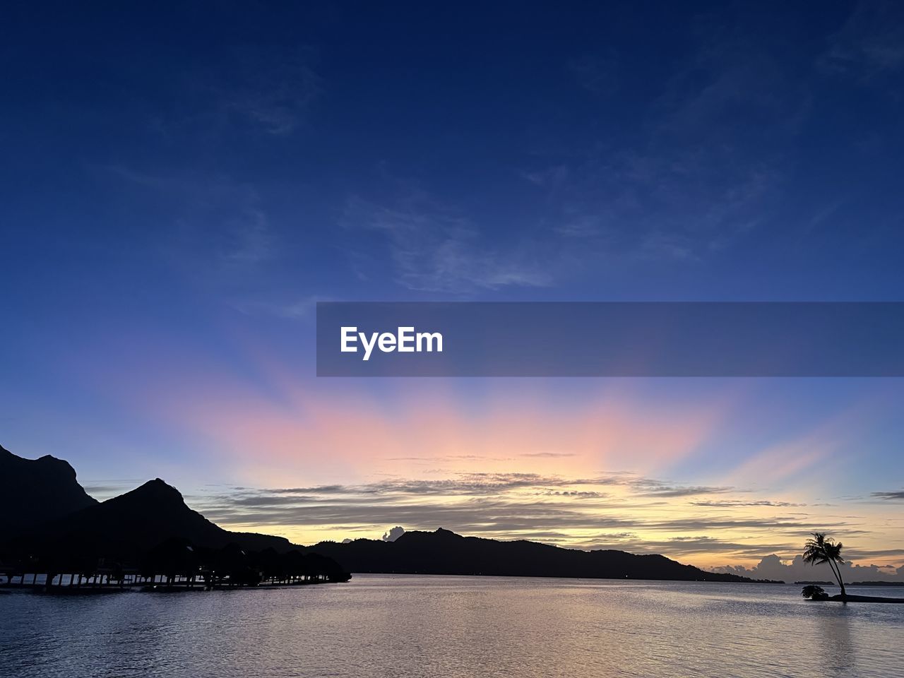 sky, water, horizon, sea, cloud, reflection, dusk, beauty in nature, scenics - nature, ocean, nature, mountain, coast, sunset, evening, nautical vessel, bay, tranquility, shore, environment, land, landscape, travel destinations, travel, blue, tranquil scene, transportation, beach, no people, outdoors, body of water, dramatic sky, sunlight, holiday, wave, silhouette, seascape, vacation, idyllic, trip, tourism