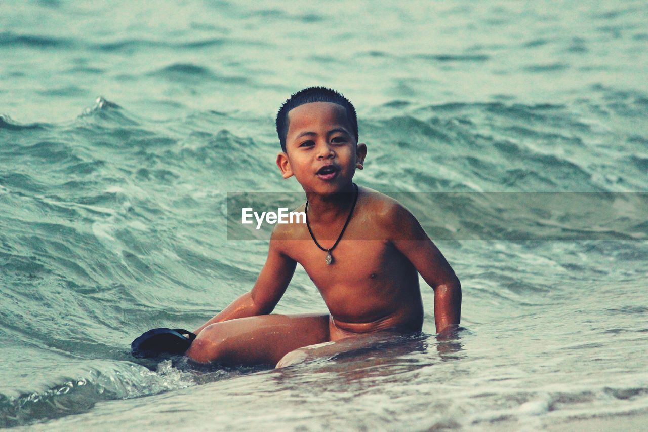 Portrait of boy swimming in sea