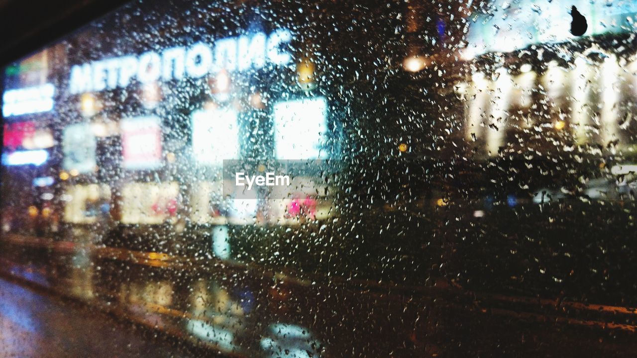 CLOSE-UP OF WET WINDOW IN CAR