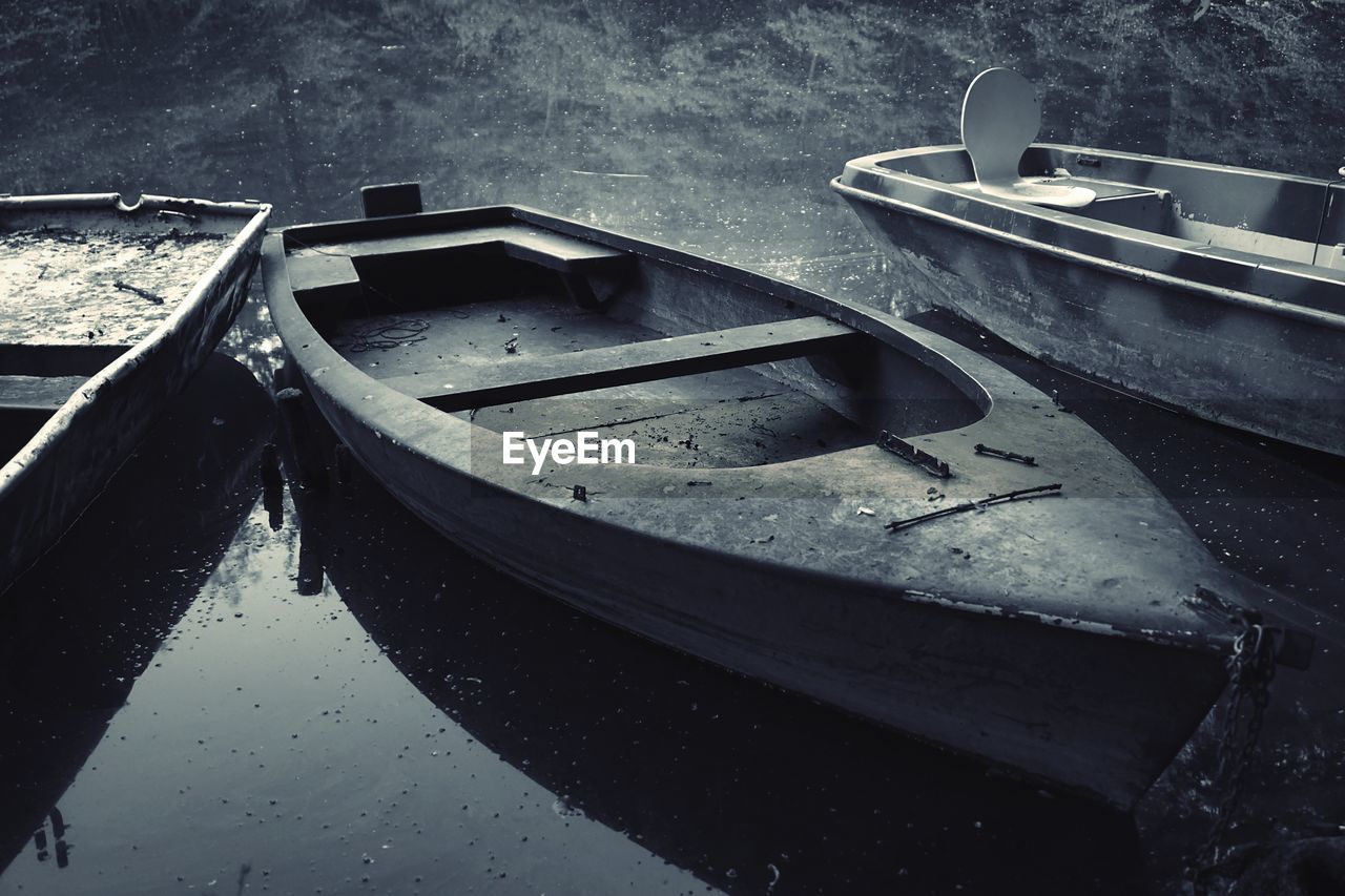 HIGH ANGLE VIEW OF ABANDONED BOAT MOORED AT LAKE