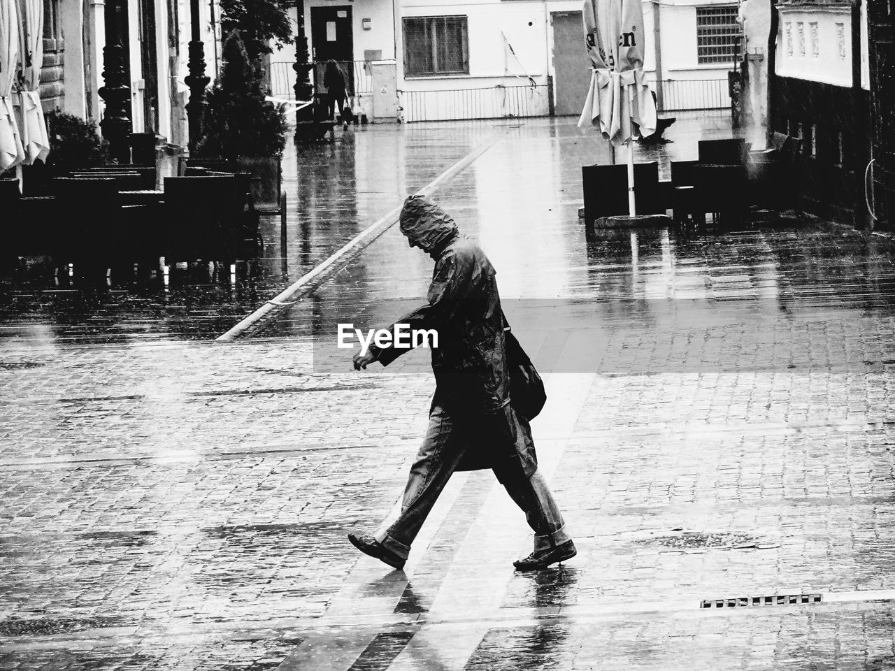 Man walking on street during rainfall