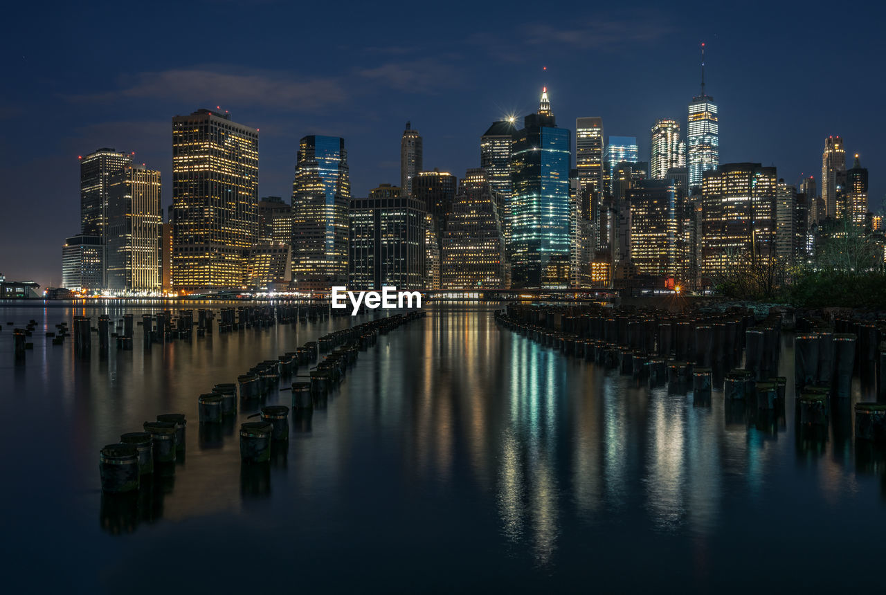 Illuminated city at waterfront