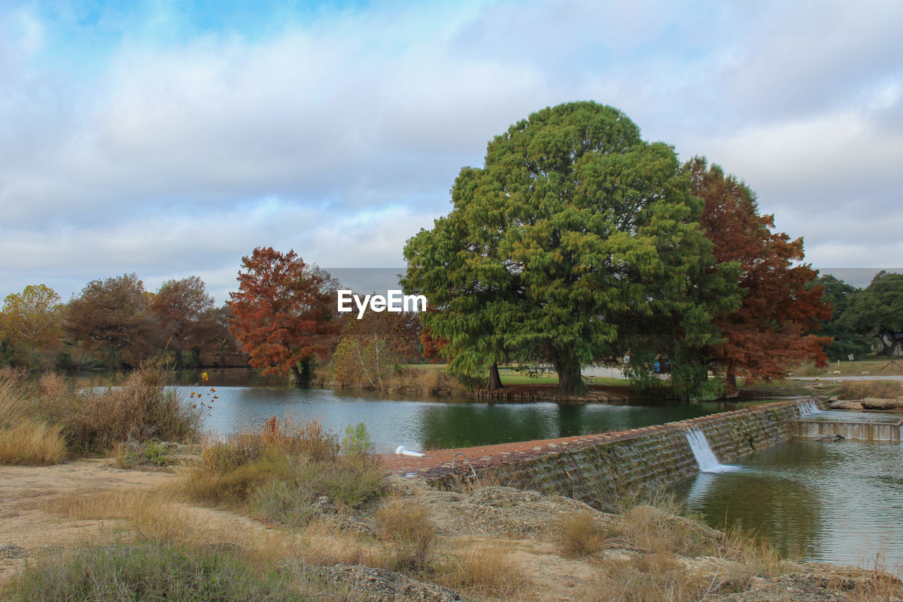 tree, plant, water, river, sky, cloud, nature, environment, rural area, scenics - nature, beauty in nature, reservoir, no people, landscape, tranquility, reflection, autumn, land, waterway, tranquil scene, pond, outdoors, day, non-urban scene, grass, travel destinations, travel, tourism, growth