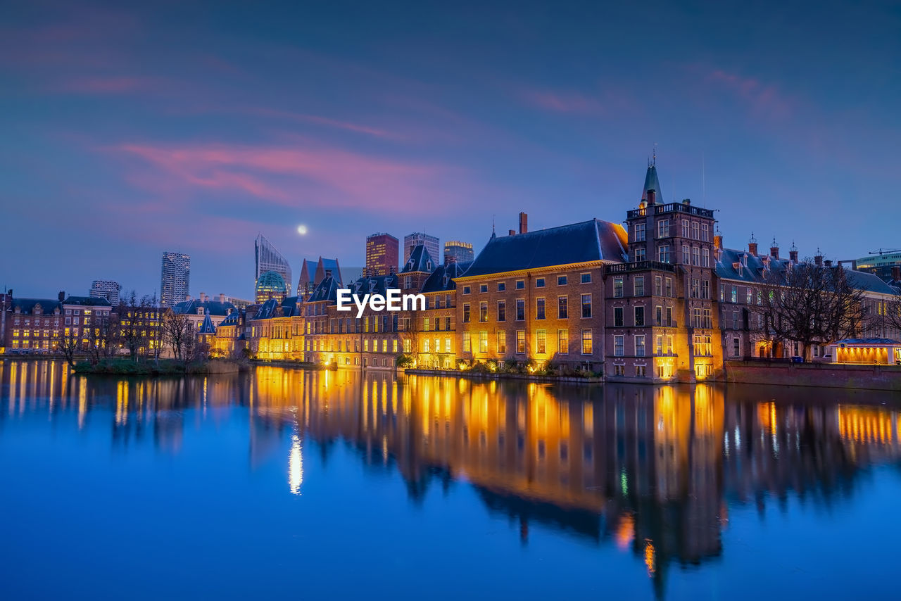 illuminated buildings in water