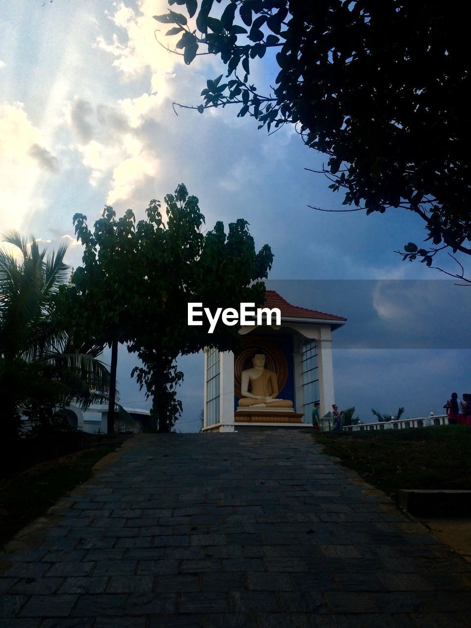 Low angle view of buddha statue against sky