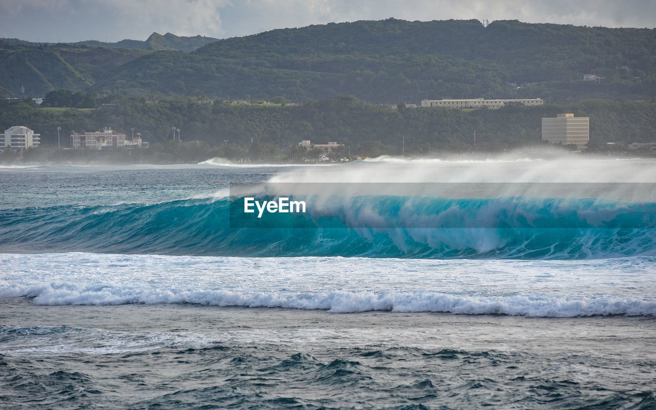 SCENIC VIEW OF SEA WAVES SPLASHING ON LAND
