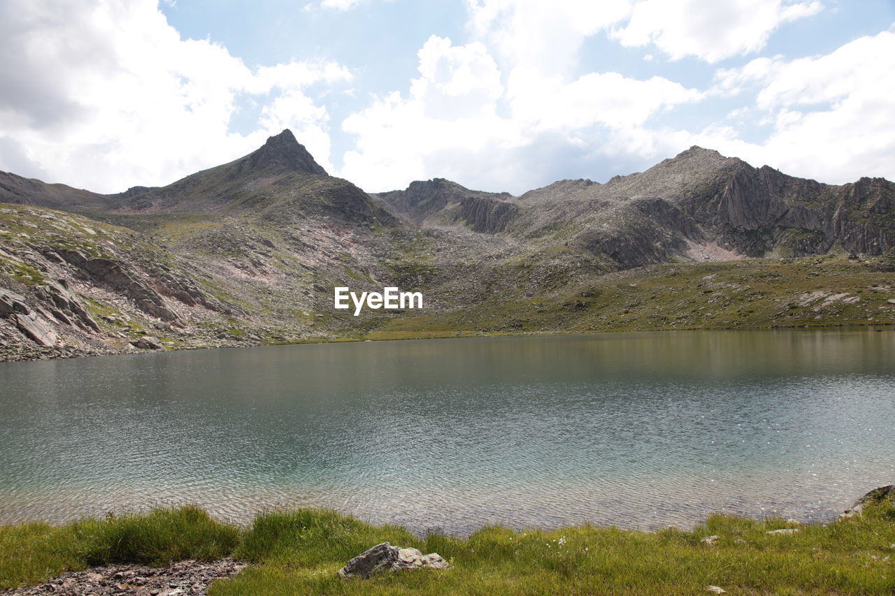 Scenic view of lake and mountains against sky