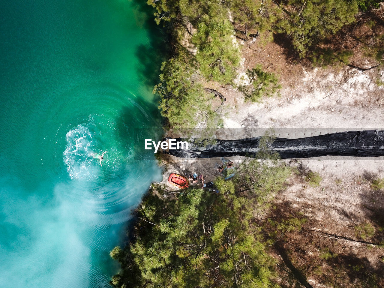 Aerial view of man swimming in lake