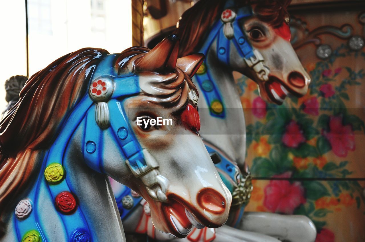 Close-up of carousel horses at amusement park