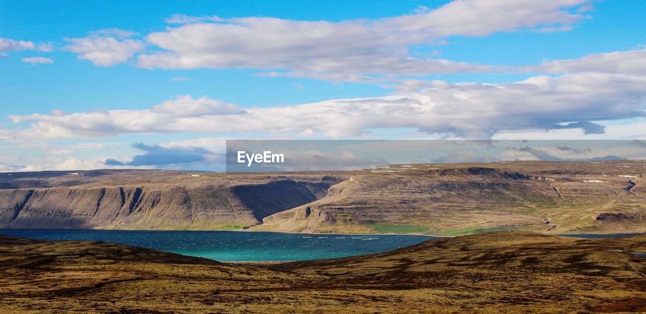 Scenic view of mountains against cloudy sky