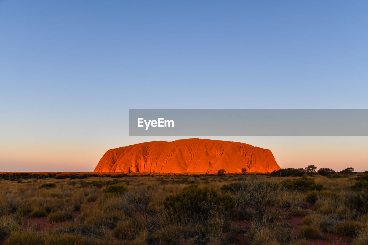 ROCK FORMATION ON LANDSCAPE AGAINST CLEAR SKY