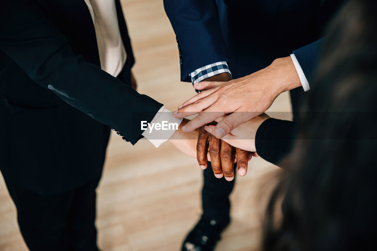 midsection of businessmen shaking hands