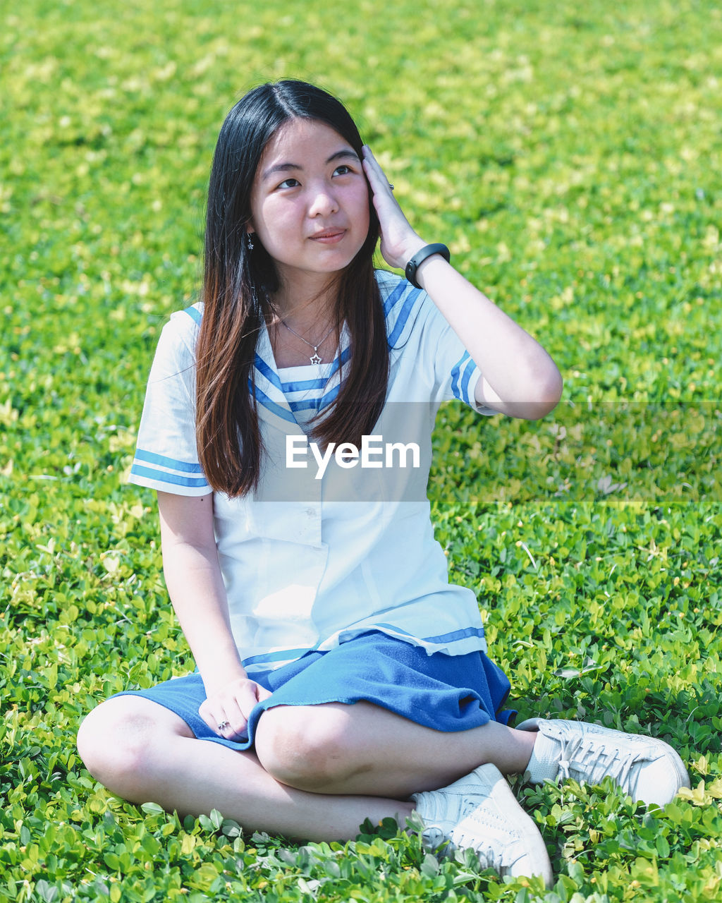 Smiling young woman sitting outdoors