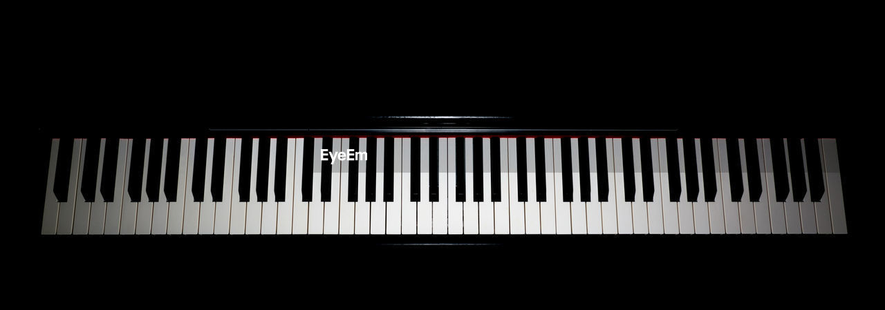 Close-up of piano keys against blue background