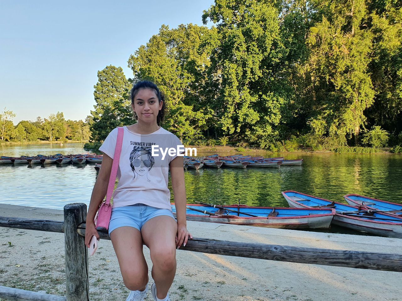 portrait of young woman sitting in boat on lake