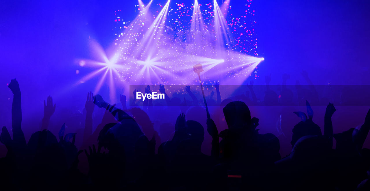 Double exposure of audience at nightclub