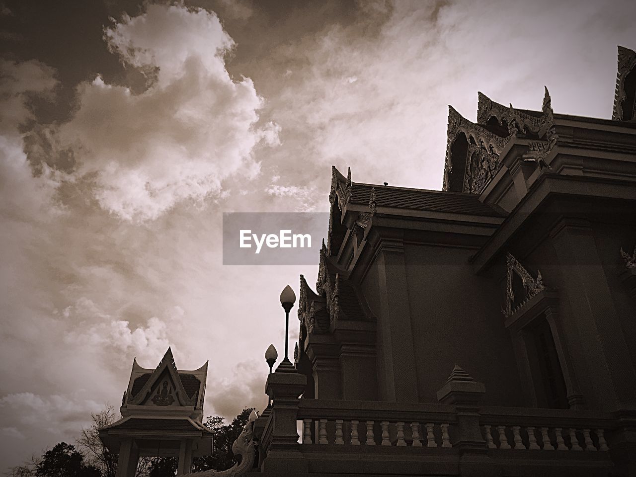 Low angle view of building against cloudy sky