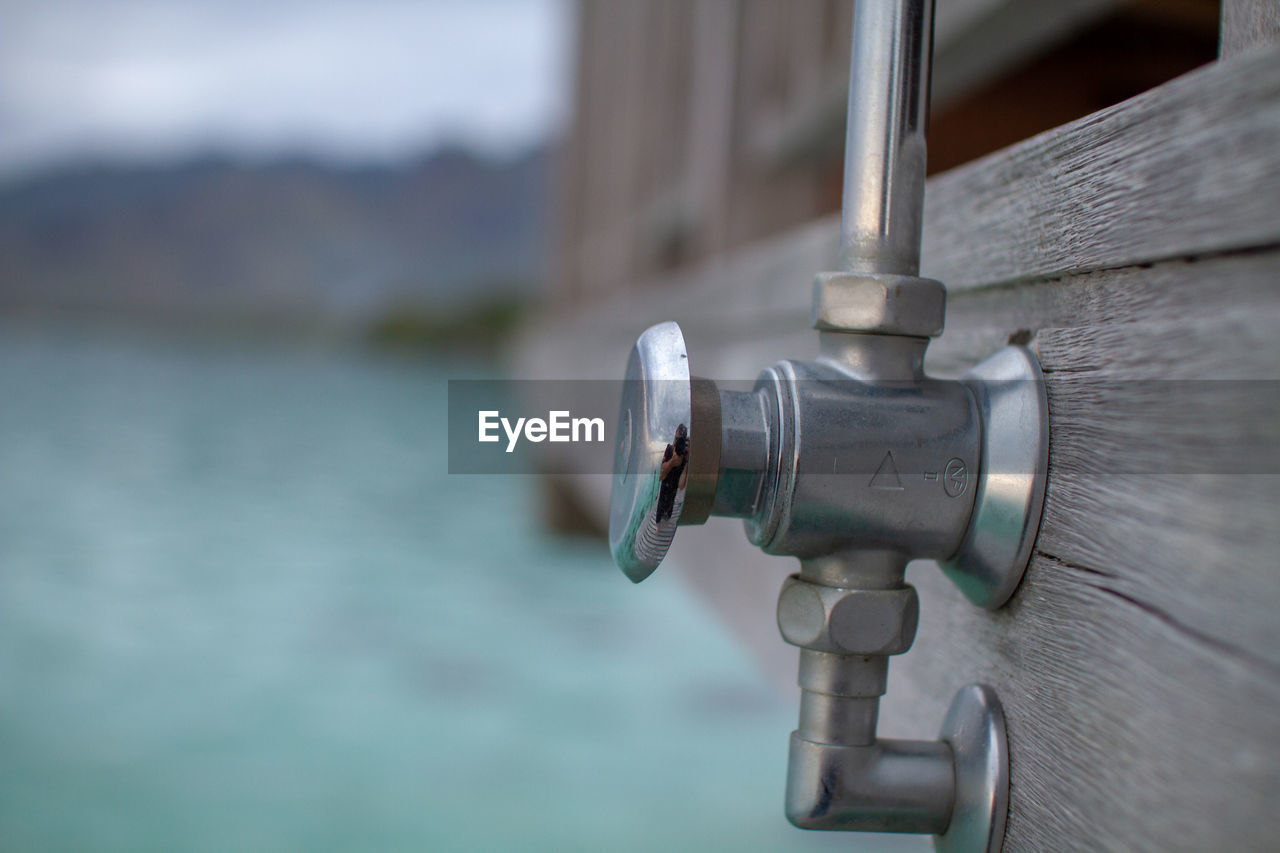 Closeup of pipe showing reflection, beautiful ocean in background 