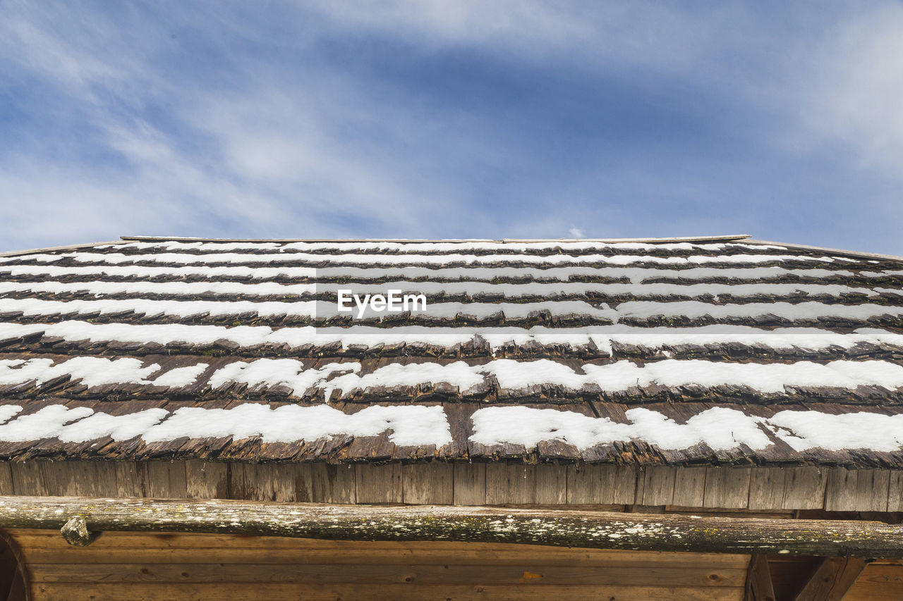 Rotten wooden roof covered with snow. alp village in triglav national park in slovenia.
