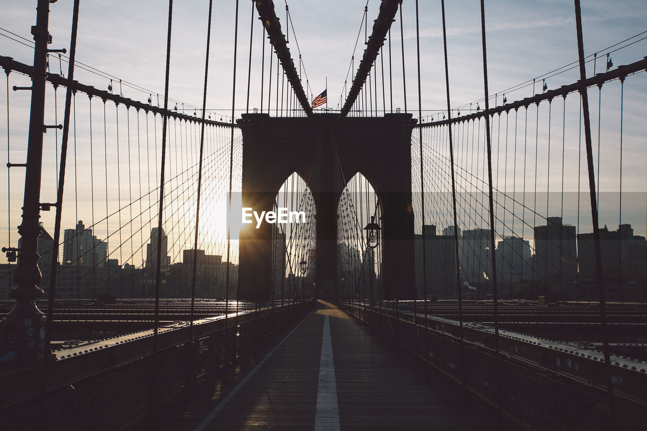 View of suspension bridge against sky during sunset