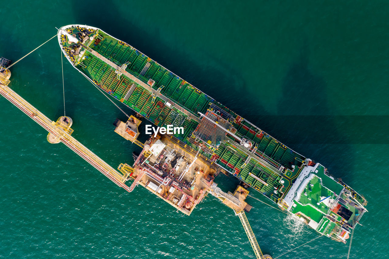 High angle view of shipping oil and gas loading terminal on green sea