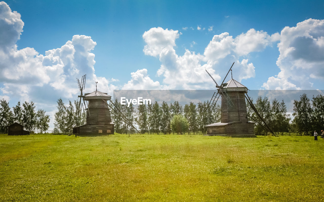 Traditional windmill on field against sky