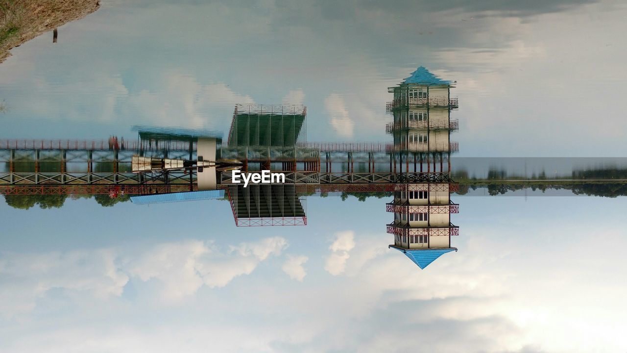 Upside down image of building reflecting in lake