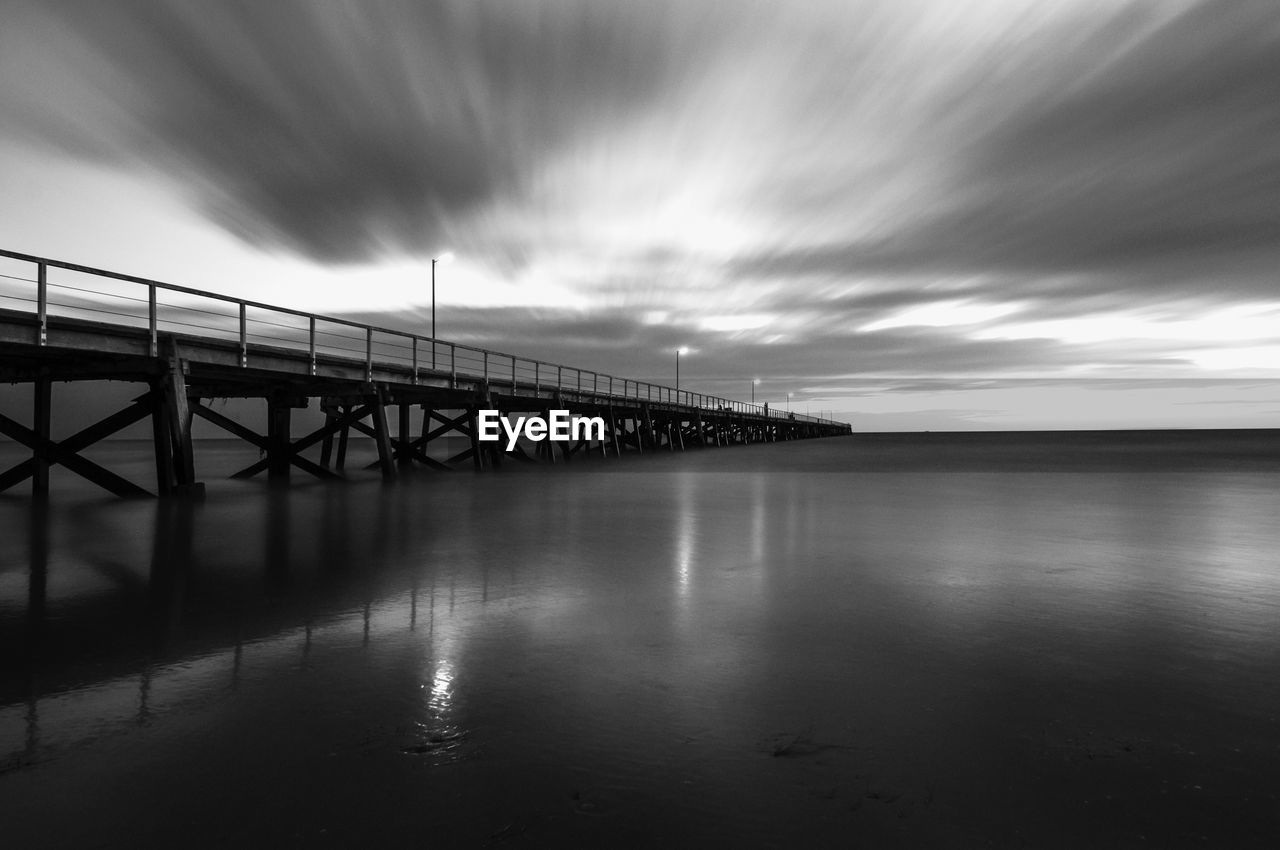 Low angle view of bridge over calm sea