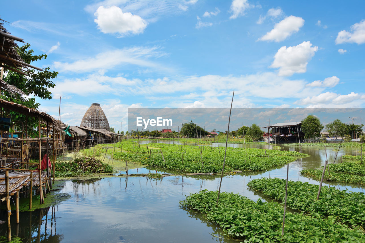 Thai market on the edge of the canal with sky as background