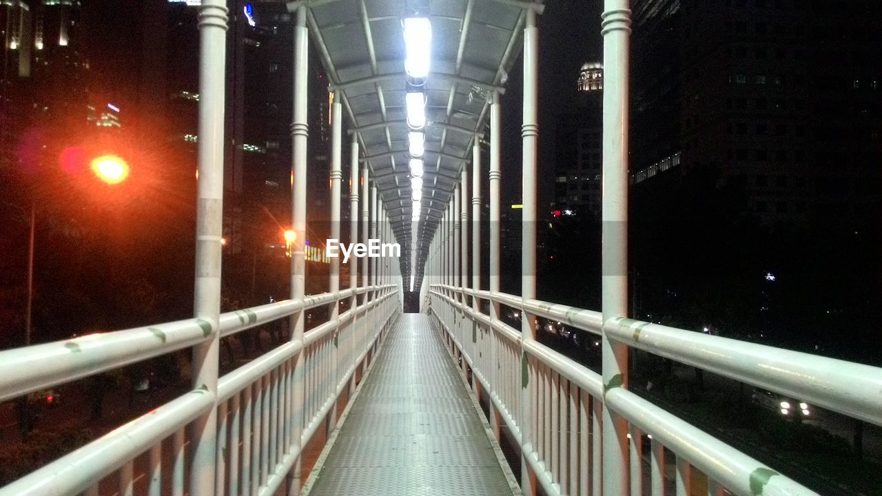 VIEW OF ILLUMINATED BRIDGE AT NIGHT