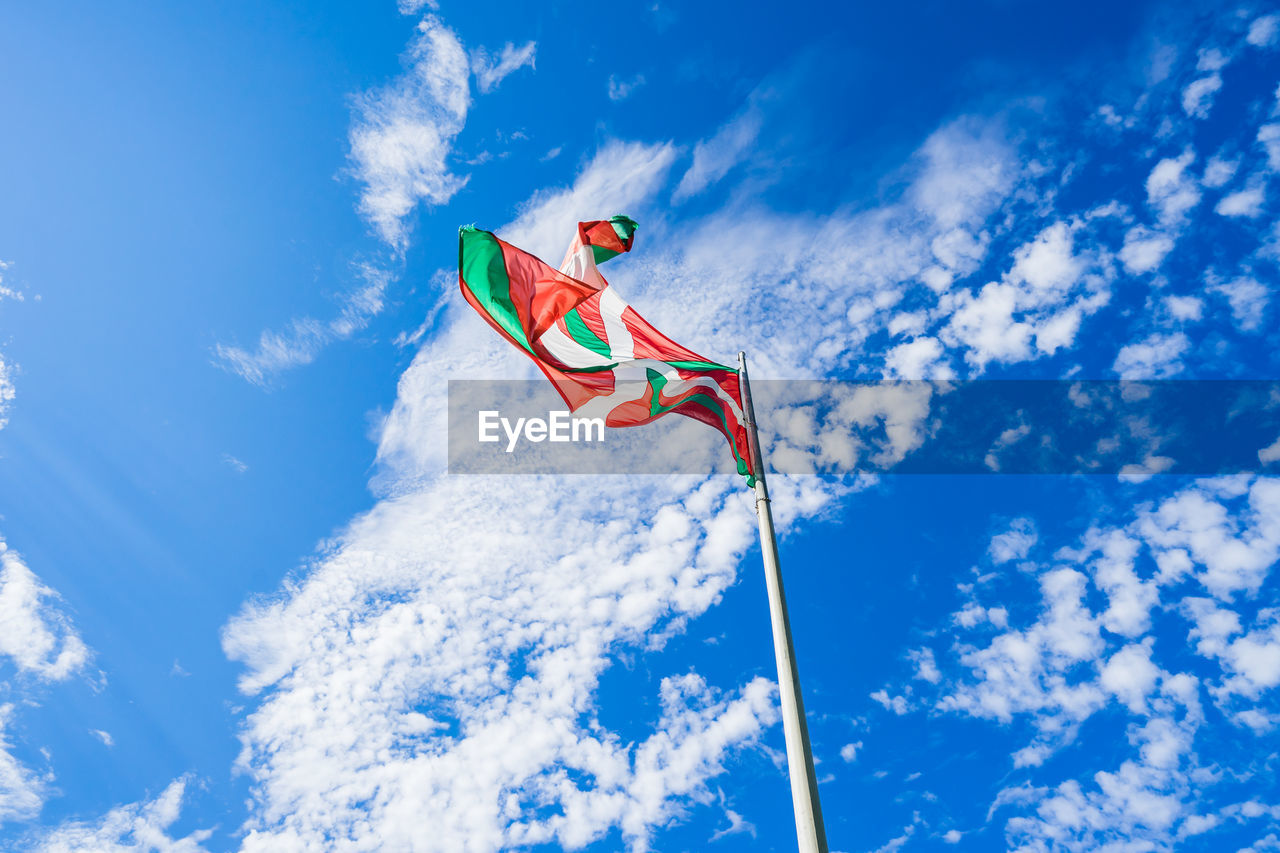 Low angle view of crane against blue sky