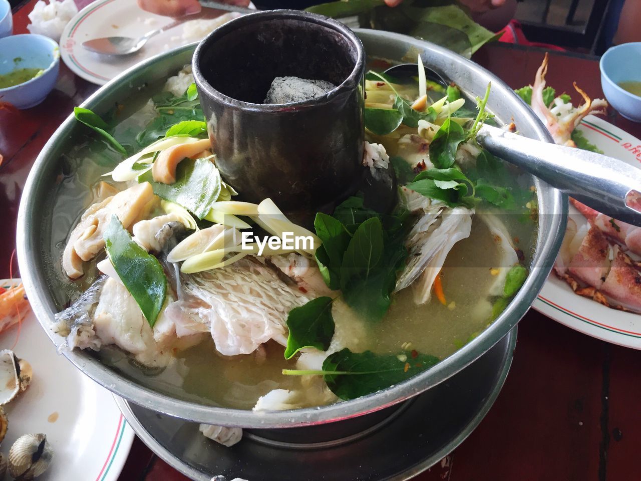 High angle view of tom yum soup served on table