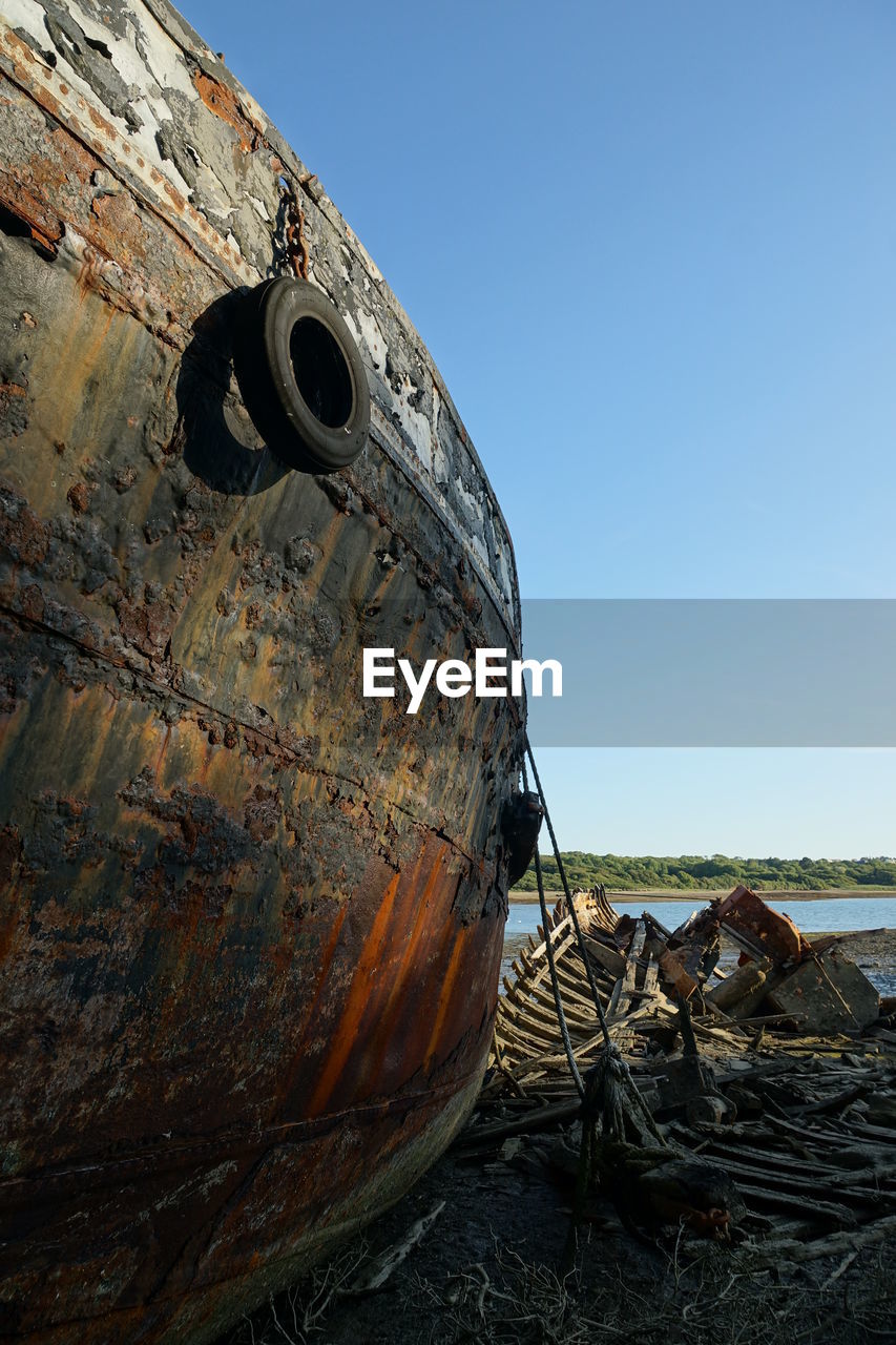 ABANDONED BOAT AGAINST SKY