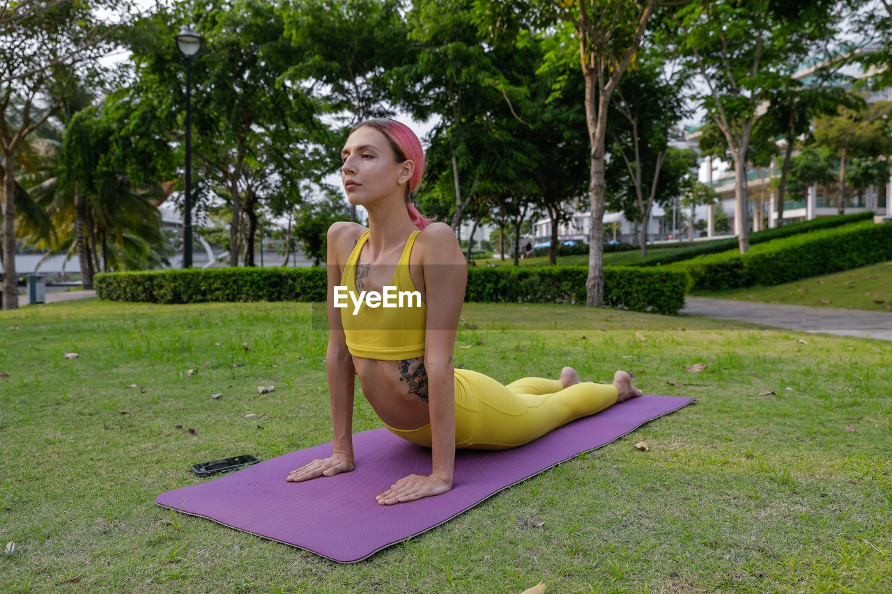 portrait of young woman exercising in park