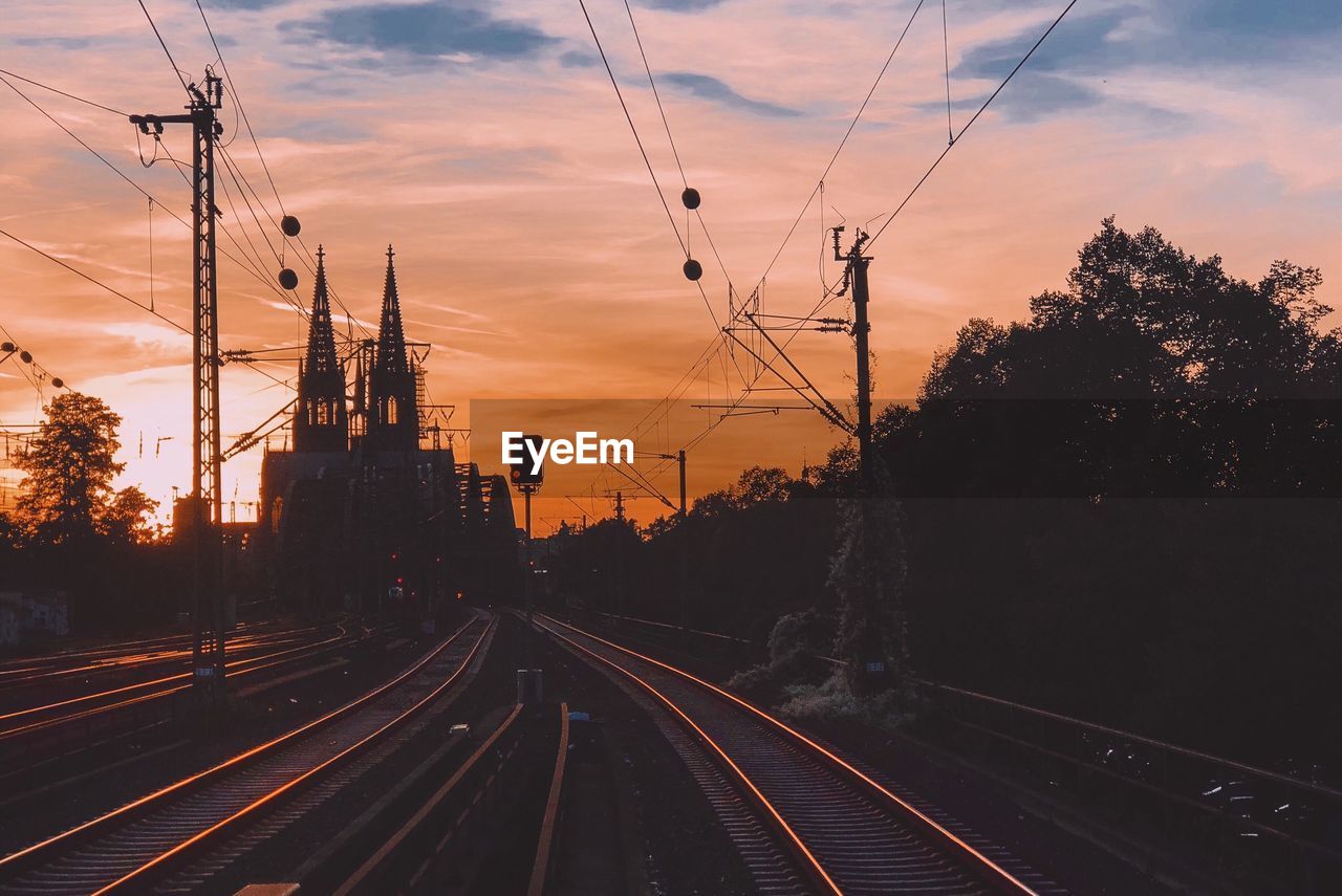 Empty railroad tracks during sunset