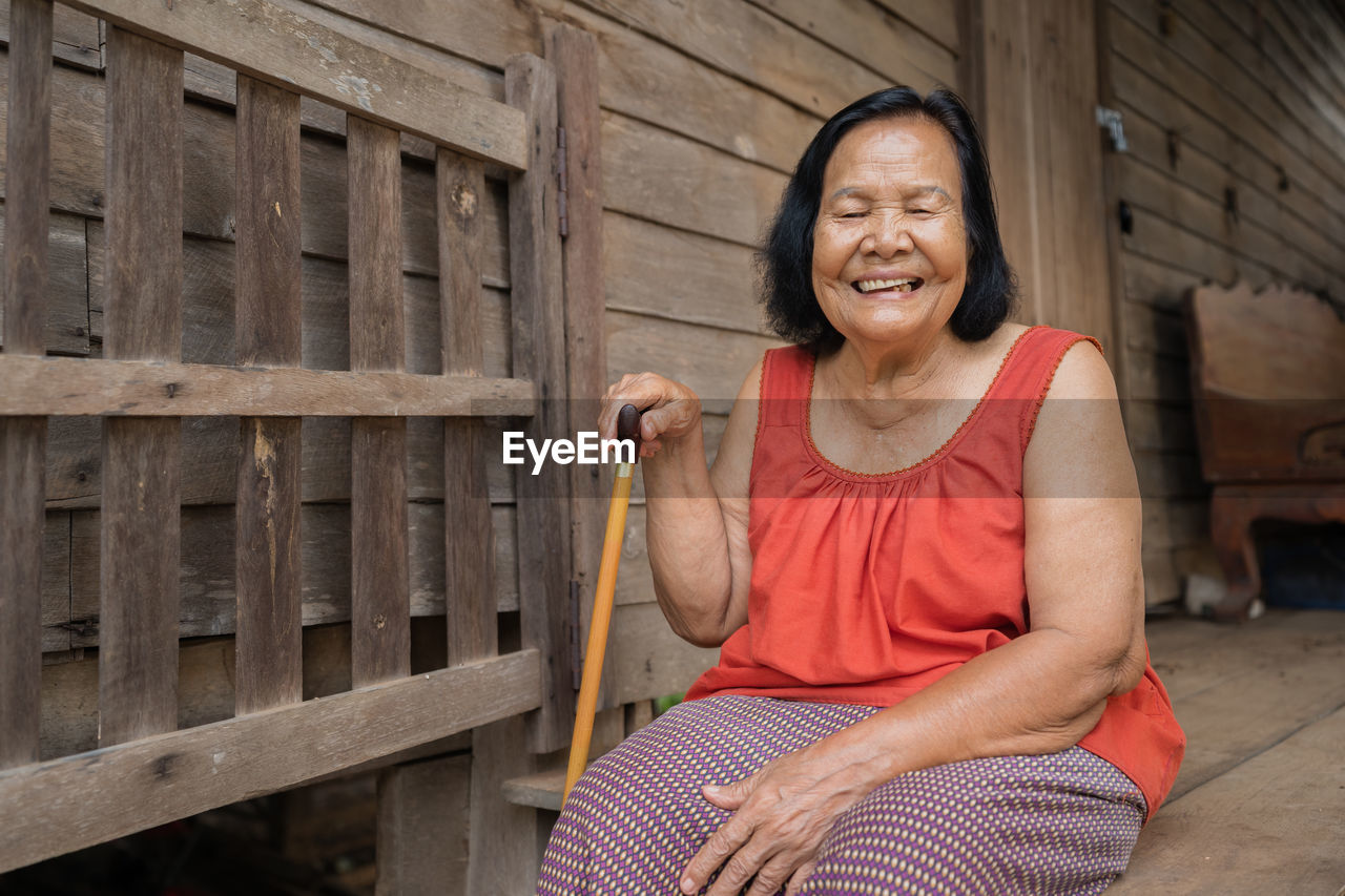 Smiling senior woman sitting outdoors