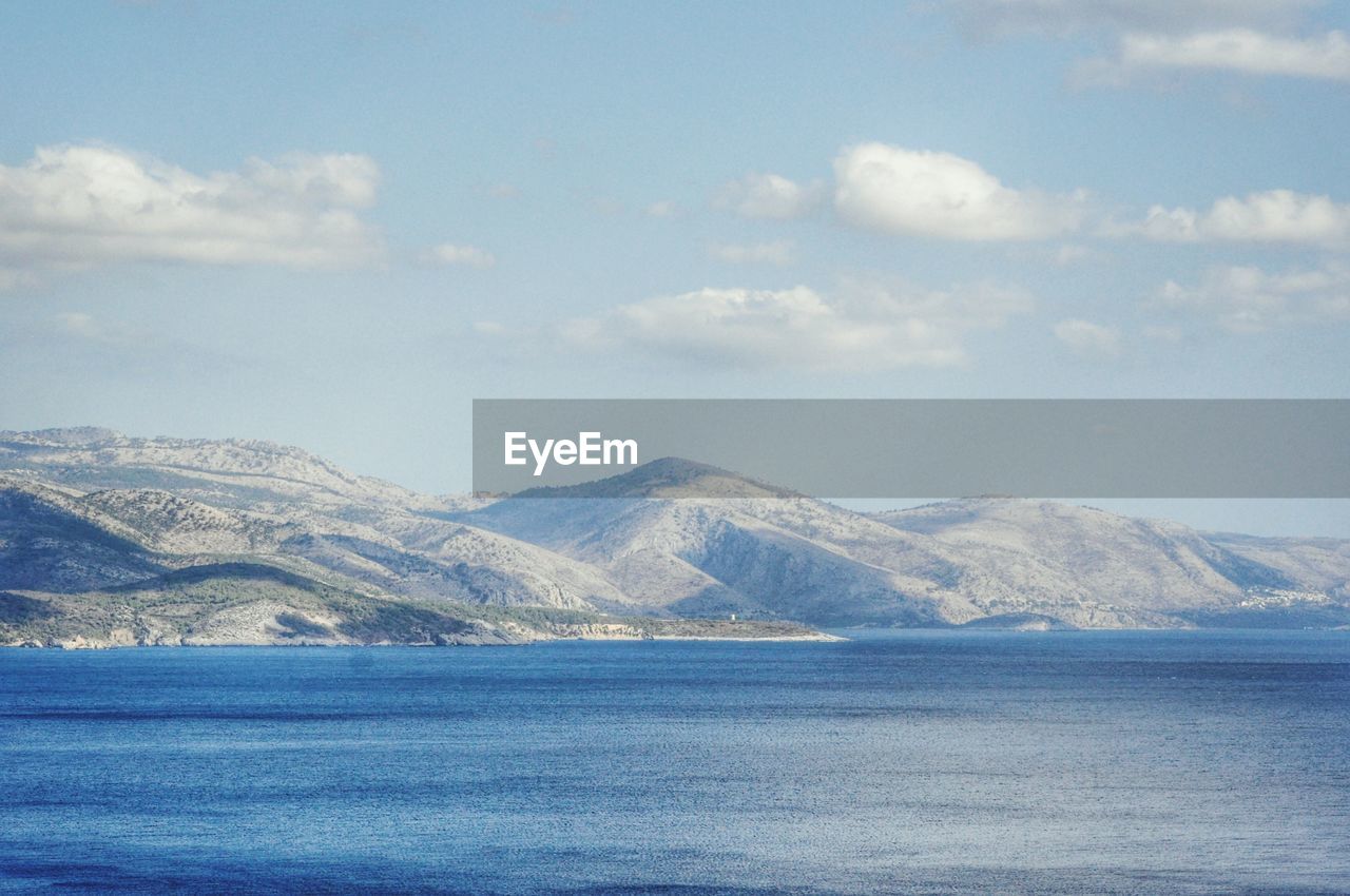 Scenic view of mountain against cloudy sky