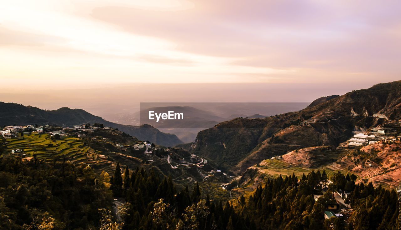 Scenic view of mountains against sky at sunset